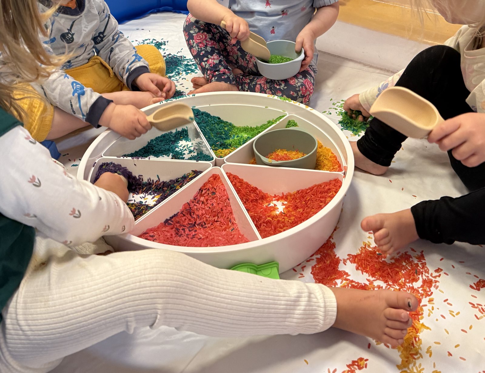 Children playing with coloured rice