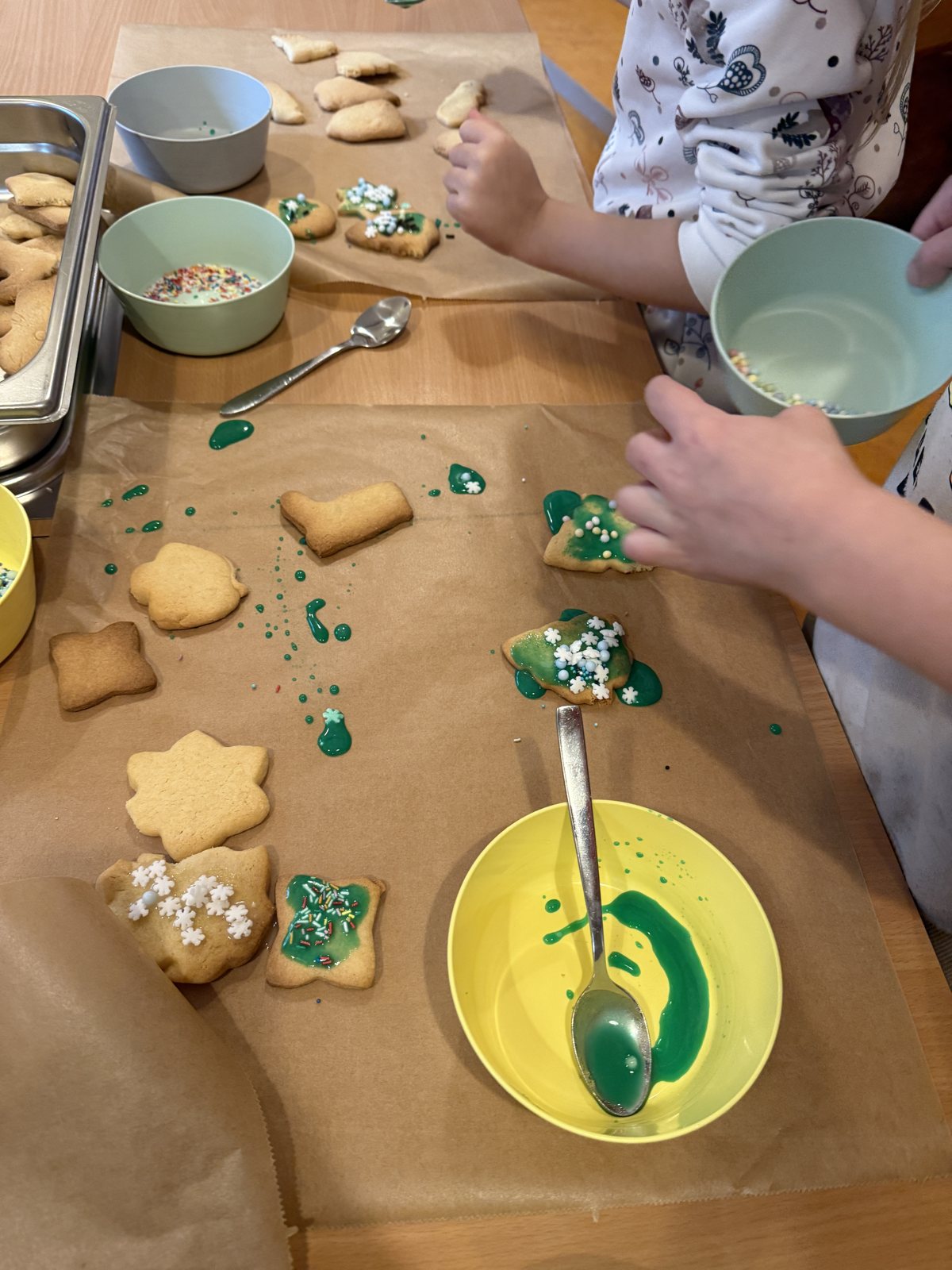 Children's hands decorating cookies