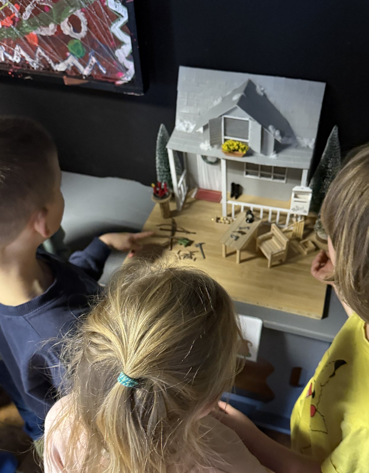 Children looking at the miniature house